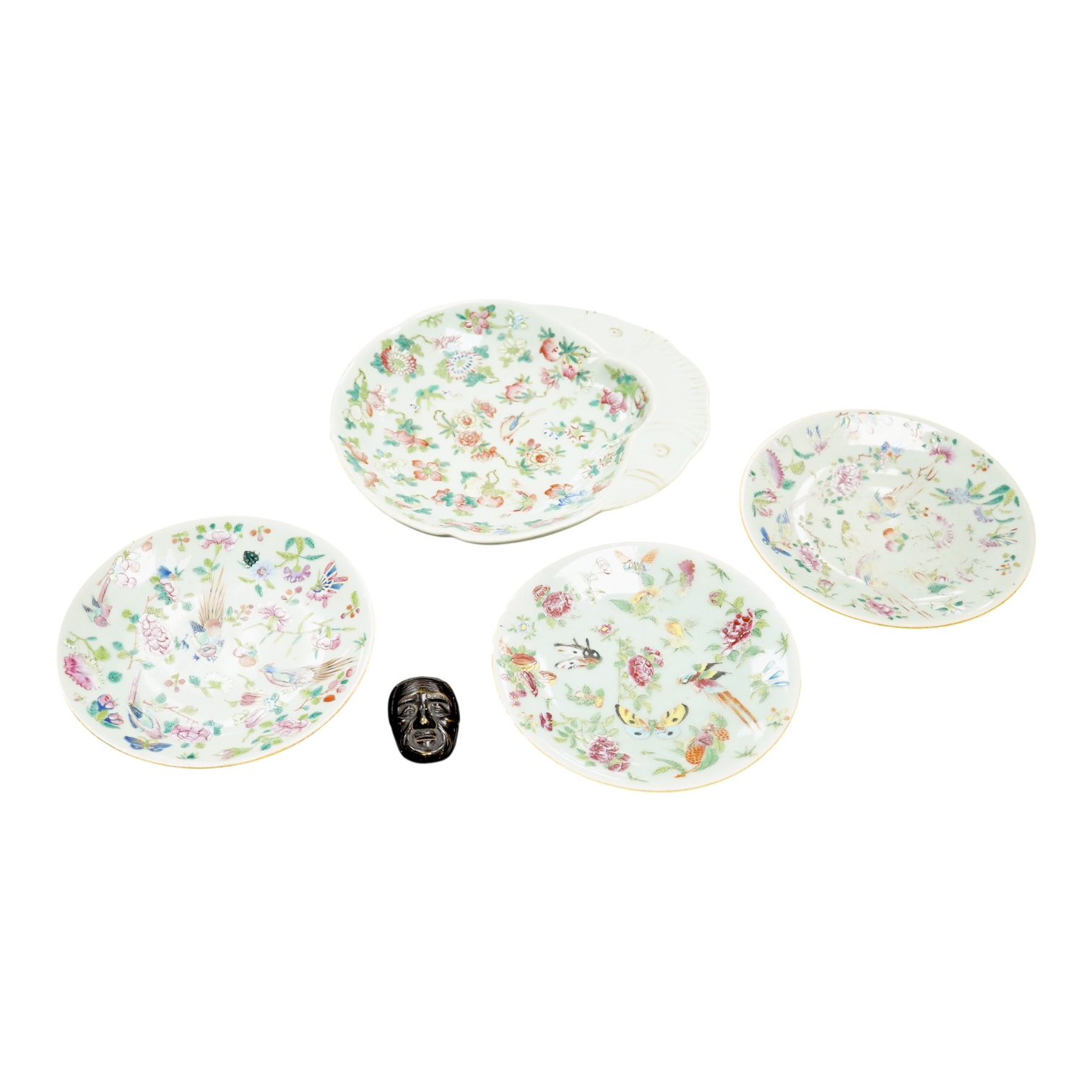 A Japanese bronze mask and four famille rose dishes - largest 29cm